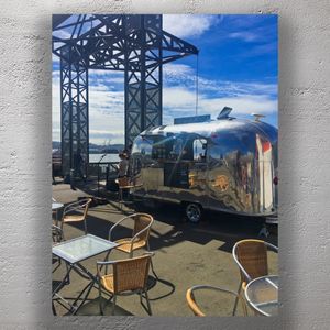 Trendy Waterfront Coffee Van with Outdoor Seating Industrial Urban Café Scene Photo Download