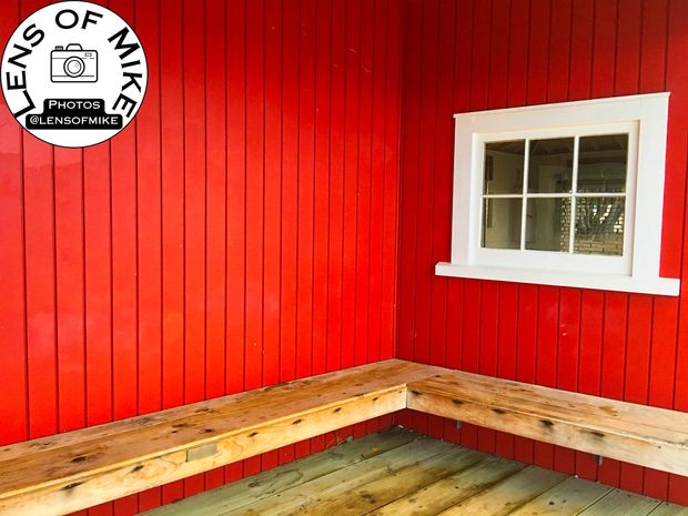 Rustic Wooden Bench Against Red Timber Wall with White Framed Window Photo Download