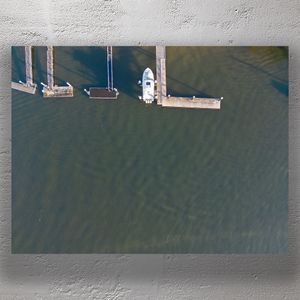 Aerial View of Boat Docked at Jetty in Clear River Water Photo Download