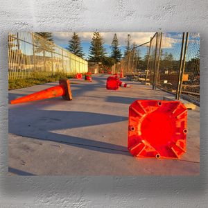 Scattered Traffic Cones on Construction Site at Sunset Photo Download