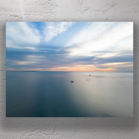 Tranquil Sunrise Over Calm Ocean with Sailboats Serene Seascape Photo Download