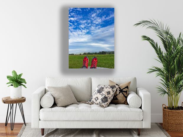 Relaxing Outdoors Feet Up with Red Running Shoes Against a Scenic Blue Sky Photo Download