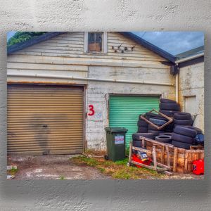 Abandoned Garage with Stacked Tires Urban Decay and Rustic Charm Photo Download