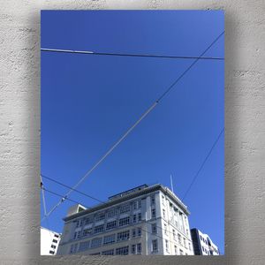 Urban Skyline with Power Lines Against Clear Blue Sky City Architecture Photo Download