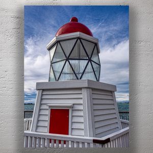 Red and White Lighthouse by the Water Under a Cloudy Blue Sky Photo Download
