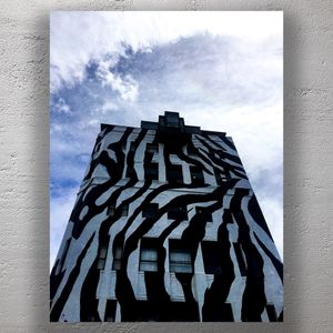 Zebra Stripes Building Striking Black and White Architecture Against a Cloudy Sky Photo Download