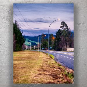 Peaceful Country Road at Dusk Rural Landscape with Street Lights and Rolling Hills Photo Download