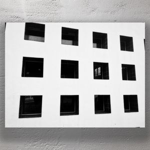 Minimalist Black and White Building Facade with Grid Pattern Windows Photo Download