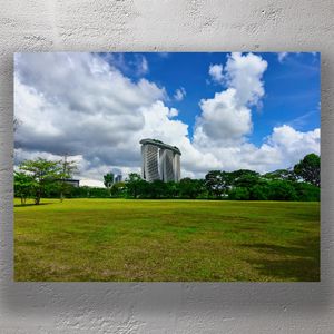 Marina Bay Sands Singapore with Lush Greenery Under a Vibrant Blue Sky Photo Download
