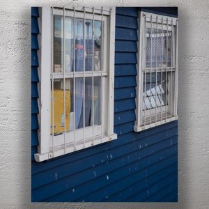 Blue Wooden Building with Barred Windows and Weathered Paint Urban Texture Photo Download