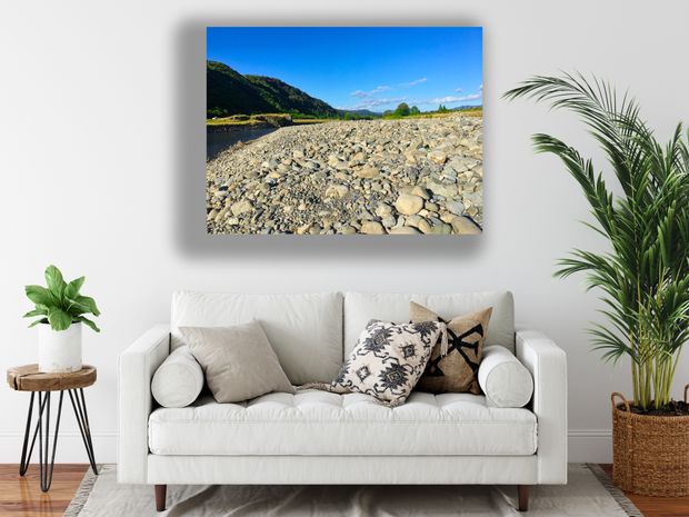 Rocky Riverbank Landscape Tranquil Nature View with Blue Sky and Green Hills Photo Download