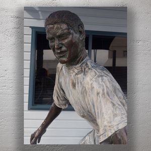 Bronze Surfer Sculpture Outside Coastal Building Photo Download