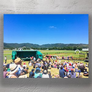 Vibrant Outdoor Event at Trentham Racecourse Crowds Stage and Scenic Backdrop Photo Download