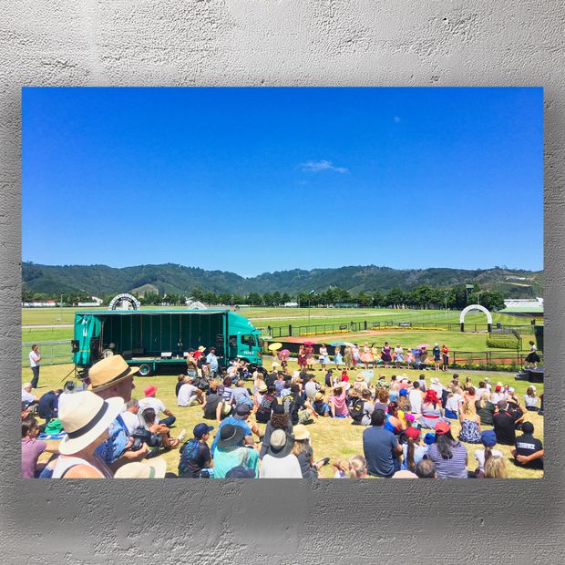 Vibrant Outdoor Event at Trentham Racecourse Crowds Stage and Scenic Backdrop Photo Download