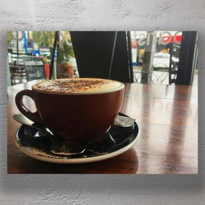 Cozy Cappuccino in Café Setting with Chocolate Dusting Relaxing Coffee Moment Photo Download