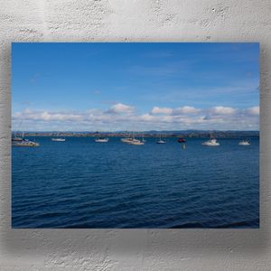 Tranquil Blue Bay with Anchored Sailboats Under Scenic Sky Photo Download
