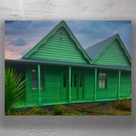Vibrant Green Heritage House Under Moody Sky Photo Download