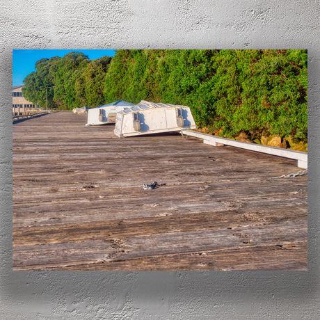 Beached Rowboats on Wooden Jetty Beside Lush Greenery Photo Download
