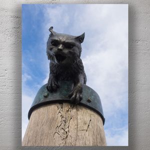Fierce Cat Sculpture on Wooden Post Against Blue Sky Quirky Outdoor Art Photo Download