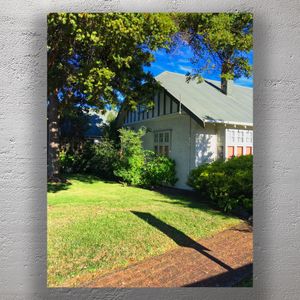 Charming Vintage Cottage with Lush Garden and Blue Sky Photo Download