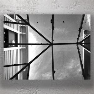 Geometric Glass Roof Structure with Reflections Black and White Architectural Photo Download