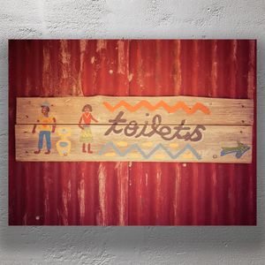Rustic Hand-Painted Toilets Sign on Corrugated Metal Wall Photo Download