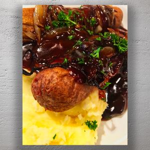 Classic British Bangers and Mash with Onion Gravy and Parsley Garnish Photo Download