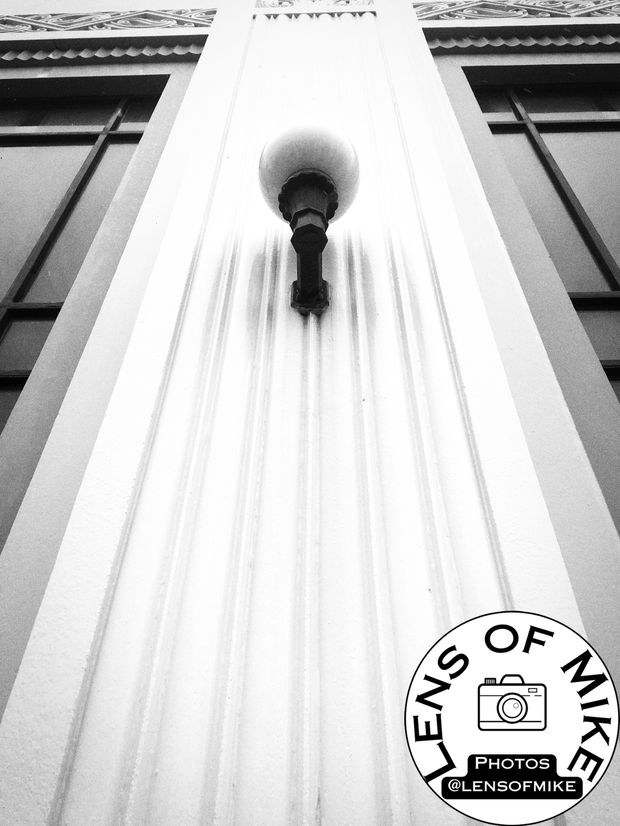 Art Deco Wall Lamp on Ornate Facade Symmetrical Architectural Detail Photo Download