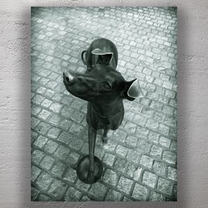 Playful Dog Sculpture on Cobblestone Street Whimsical Urban Art Photo Download