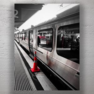 Urban Train Station Scene with Selective Color Orange Safety Cone on Platform Photo Download