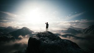 Young man standing on top of mountain