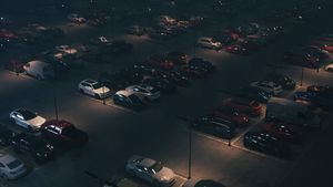 Cars at night in the parking lot. Aerial view of night parking