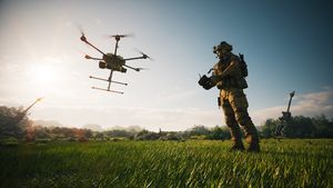 A soldier operates a drone in a field. Combat use of drones