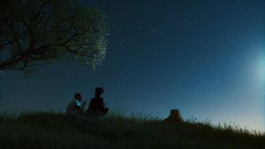 Guy and girl talking under the night sky