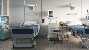 Two empty bed in a hospital room with medical equipment