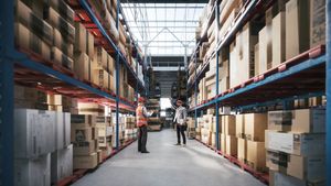 Man and woman workers of a large warehouse