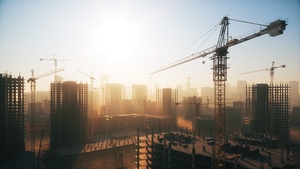 Large construction site with tall construction buildings and cranes