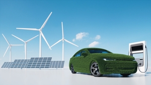 Electric car charger station and wind turbines. Grass covered car