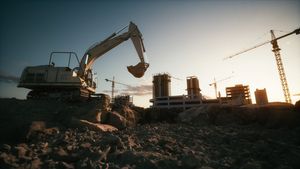 Excavator in a pit against the construction site