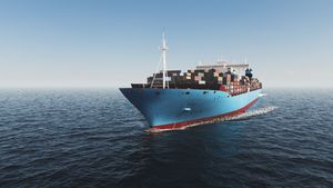 Aerial shot of fully loaded container ship cruising open ocean
