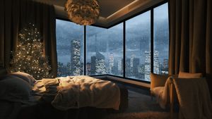 Cozy bedroom with snow outside the window. View from bedroom to the night city