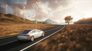 Electric car drives along a windmills