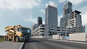 Concrete mixer truck on the background of building houses