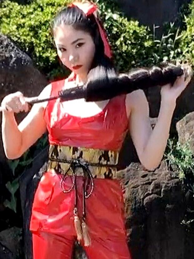 VIDEO - Very long black hair and a red suit