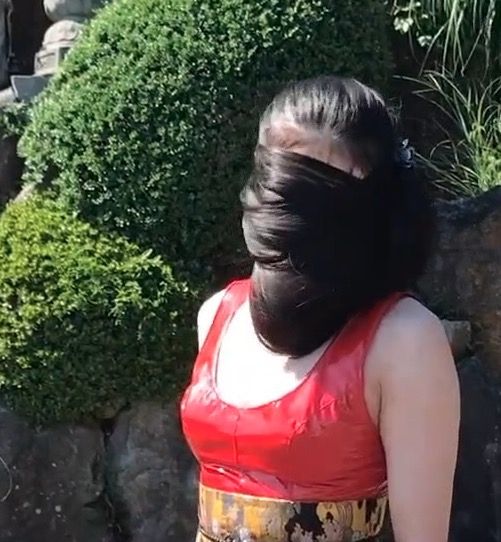VIDEO - Very long black hair and a red suit