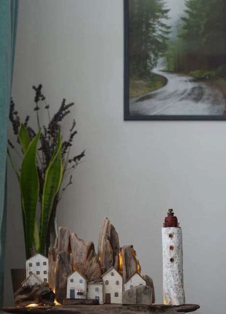 Nightlight driftwood houses and lighthouse on the rocks