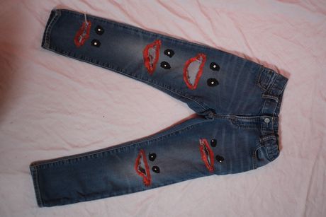 Hand-painted pants with holes that are mouths.